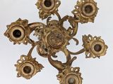 an image of a gold colored chandelier hanging from a ceiling