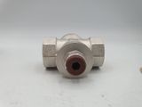 a close up of a metal ball valve on a white surface