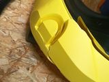 a yellow blow dryer sitting on the floor next to a black hose