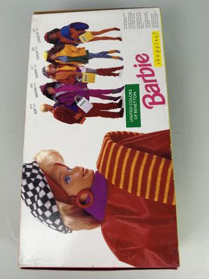 La poupée Barbie se trouve dans la boîte posée sur la table.