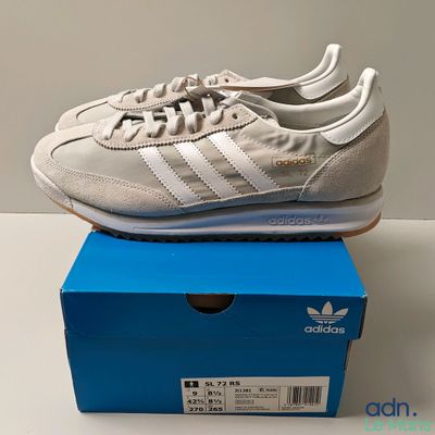 the adidas sneakers are in a box on a white surface