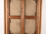 an old wooden frame with a window in the middle of it