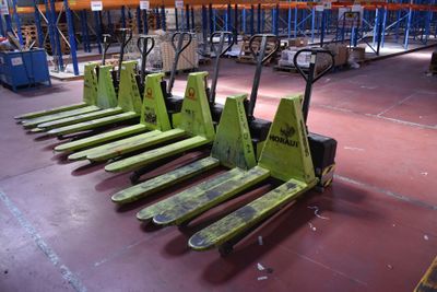 many pallets that are sitting on the floor in the warehouse