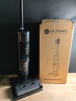 the vacuum is sitting on the table next to the box
