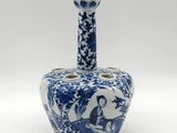 an old blue and white vase with a bird on it ' s neck