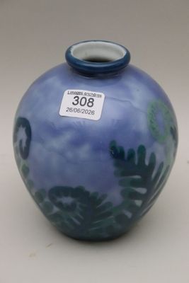 a blue vase with a blue lid sitting on a table