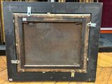 a picture of an old picture frame on the floor