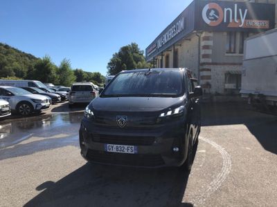 a black van parked in a parking lot next to a building