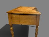 a small wooden table with a drawer on it