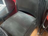 a stack of chairs and a table in a room