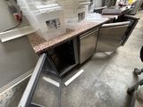a picture of a kitchen with a lot of clutter on the counter