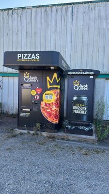 a black trash can sitting in front of a building