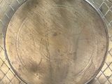a metal plate with a design on it sitting on a table