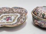 a small bowl with a lid and a small bowl with a lid on it