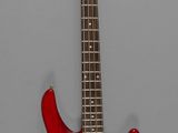 une image représentant une guitare basse électrique rouge sur fond gris