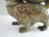 two birds sitting on top of each other on a table