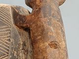 a statue of an elephant that is holding a piece of wood