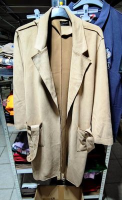 a coat hanging on a clothes rack in a store