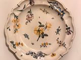 a white plate with yellow and blue flowers on it