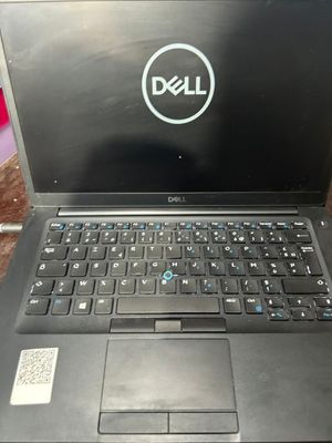 dell laptop computer sitting on top of a wooden table