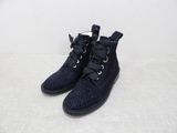 a pair of black shoes with laces on them on a white surface