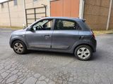a small grey car parked on the side of the road