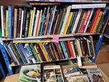 many books that are on a shelf in a room