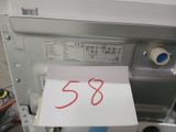 a note with the number 58 on it in front of a dishwasher