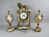 a clock and two vases sitting next to each other