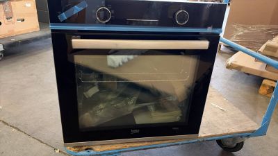 a black oven sitting on a cart in a warehouse