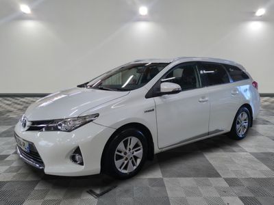 the white toyota sienna is parked on a checkered tile floor