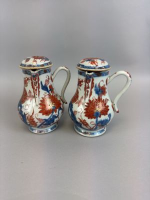 pair of chinese vases with floral designs on them on a white surface
