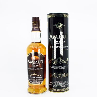 a bottle of amrut irish whiskey next to a canister