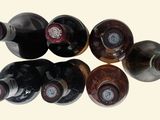 several bottles of wine are lined up in a row on a table