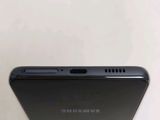 a close up of the back of a black samsung phone