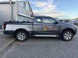 a truck parked in a parking lot in front of a building