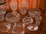 a lot of glass items sitting on a wooden table