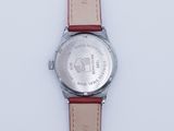 wrist watch with red leather strap on white surface with white background