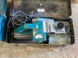 two tools in a case on the floor next to a pair of shoes