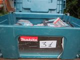 a blue tool box with tools in it sitting on a table