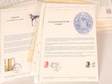 a pile of papers with stamps on them sitting on a table