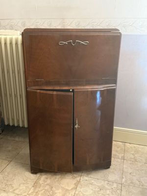 a small wooden cabinet in the corner of a room