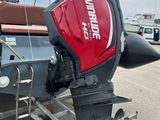 a red and black motor boat parked in a parking lot