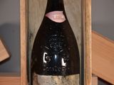 a bottle of wine in a wooden box on a table