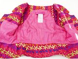 pink jacket with colorful flowers on it sitting on a white surface