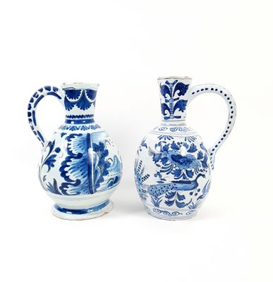 two blue and white vases sitting next to each other