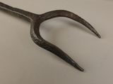 a metal fork that is on a table