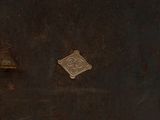an old metal box with a small metal button on it