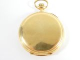 an image of a gold pocket watch on a white surface
