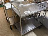 stainless steel tables and chairs in a large commercial kitchen